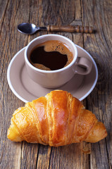 Cup of coffee and a croissant