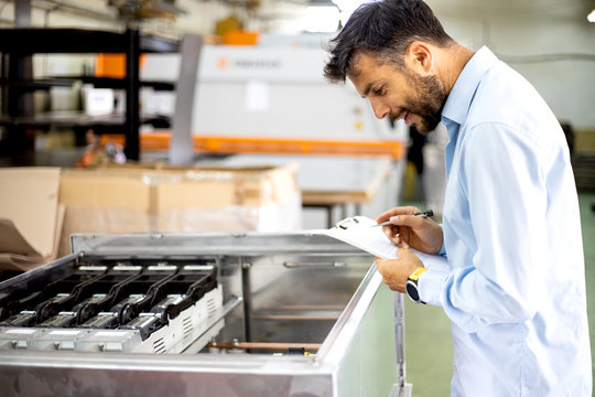 The engineer oversees the process of working in an electrical workshop,stock photo - Powered by Adobe
