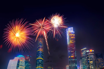 Celebration firework in twilight night cityscape of guangzhou urban skyscrapers at storm with lightning  bolts in night purple blue sky, Guangzhou, China