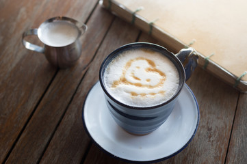 Hot coffee with milk on wooden table.