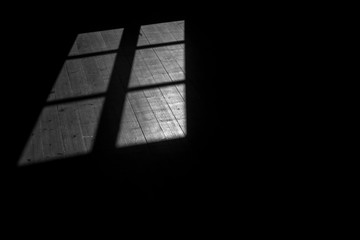 Shadow of window in black and white on old wooden floor as background
