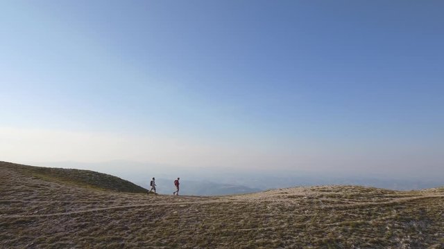 Drone view of two friends hiking in the Apennines, Umbria, Italy
