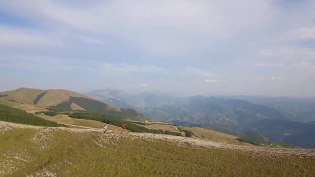 Drone view of two friends hiking in the Apennines, Umbria, Italy
