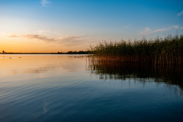 view of a beautiful lake at sunset