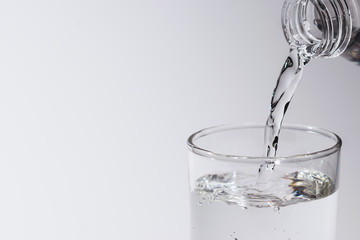 water in glass put on table under the blue sky reflection for healthy or drink, nature concept.
