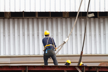 Worker pulling heavy duty steel wire
