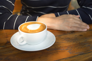 Female sit with drink latte coffee.
