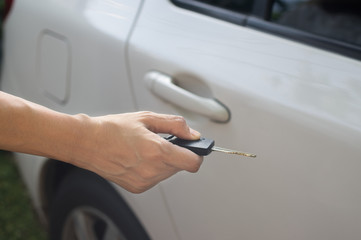 Female pressing remote systems key  for lock or unlock car.