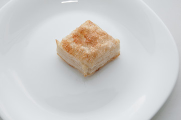 puffs of dough sprinkled with sugar on a white plate