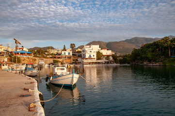 Fototapeta na wymiar Fishing boats in the small harbour of Sisi on the Greek island of Crete on a summer's evening