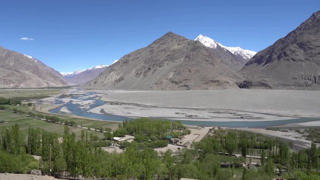 Pamir Highway Wakhan Corridor Landscape View from Abrashim Qala Fortress in Zong of the Snow Capped Mountains of Afghanistan on a Sunny Blue Sky Day
