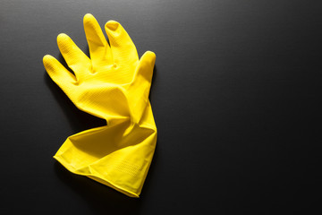 yellow rubber glove isolated on black background