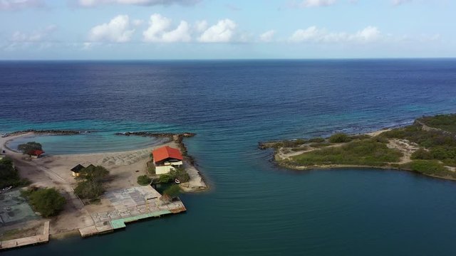 Aerial view of coast of Curaçao in the Caribbean Sea with turquoise water, cliff, beach and beautiful coral reef around Sta.Martha Bay