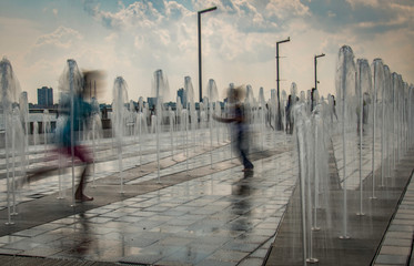 Children running through a fountain in Summer