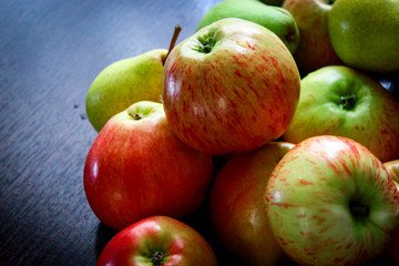 Fresh country apples and pears on the brown table