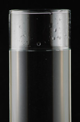water in a glass on a black background