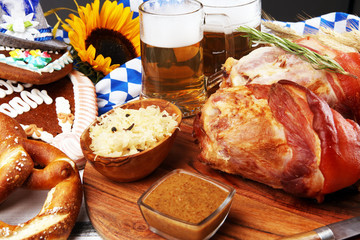 Traditional German cuisine, Schweinshaxe roasted ham hock. Beer, pretzels and various Bavarian...