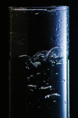 water in a glass on a black background