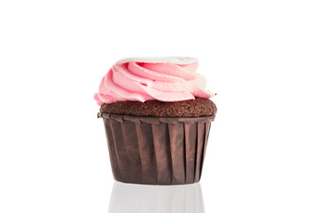 Cupcake cake with chocolate dough and pink cream on a white background