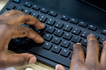 African man hands typing on keyboard