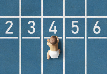 Cute toddler crawling up sport athletic platform top view