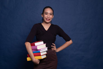 Young Asian woman studying  with may books.