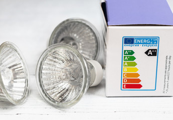 Energy efficient light bulbs, with energy rating chart. Energy and cost saving concept