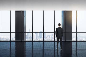 Fototapeta premium Businessman in bright office interior