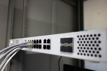 Network switch and ethernet cable connect to computer.