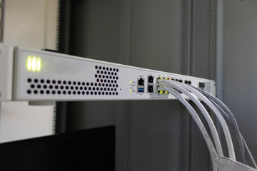 Network switch and ethernet cable connect to computer.