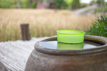 green bowl water in clay pot jar