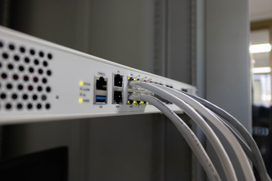 Network switch and ethernet cable connect to computer.