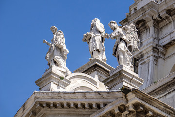 Fototapeta na wymiar Statues on the facade at Basilica of Santa Maria della Salute in Venice, Italy