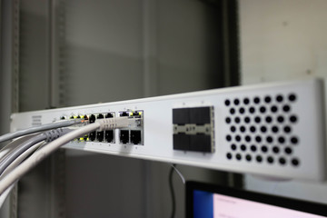 Network switch and ethernet cable connect to computer.