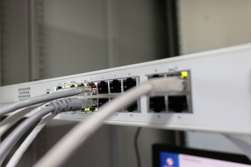 Network switch and ethernet cable connect to computer.
