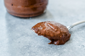 Homemade Organic Raw Nut Chocolate Cream in Spoon.