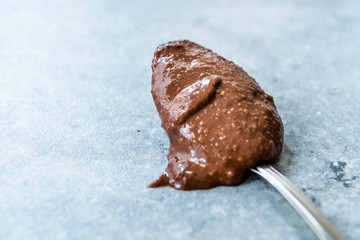 Homemade Organic Raw Nut Chocolate Cream in Spoon.