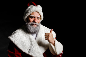 Santa Claus shows class on a black background. Santa Claus respectable