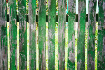 old painted green wooden fence, peeling paint