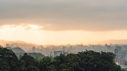 Layers of Panorama Taipei cityscape and mountains with sunlight when the sun going down that view from Xiangshan Elephant Mountain in the evening in Taipei, Taiwan.