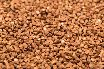 Macro Photo food buckwheat groats. Texture background grain buckwheat groats. Image food product porridge buckwheat grains