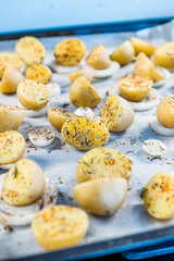 Raw Spicy Baby Potatoes on Baking Paper Ready to Bake.