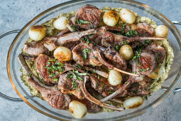 Lamb Chops with Shallots, Green Pea Hummus and Fresh Thyme Leaves served in Big Glass Tray Plate.