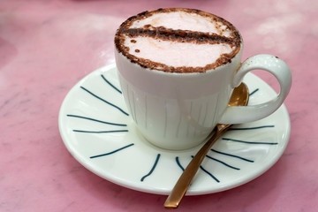 Closeup of italian espresso coffee with milk and chocolate