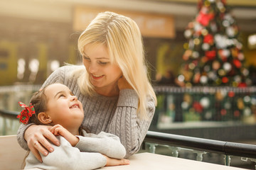 Love of mother and daughter. Happy women in a nice cafe with her cute kid. Pretty young woman and her daughter at cozy home in Christmas time. Mothers day