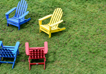 empty lawn chairs on the grass in the city park