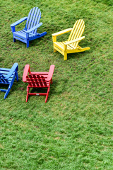 empty lawn chairs on the grass in the city park