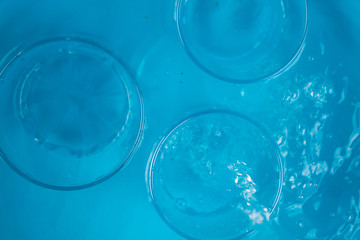 Glass of water on blue background