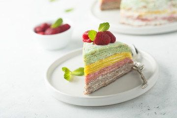 Homemade rainbow pancake cake with fresh raspberry