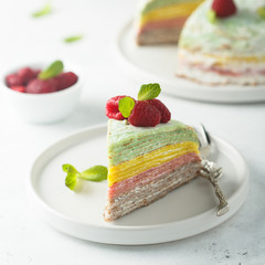 Homemade rainbow pancake cake with fresh raspberry